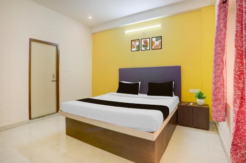 a bedroom with a large bed in a room at HOTEL O AADRITI RESIDENCY in Bhubaneshwar
