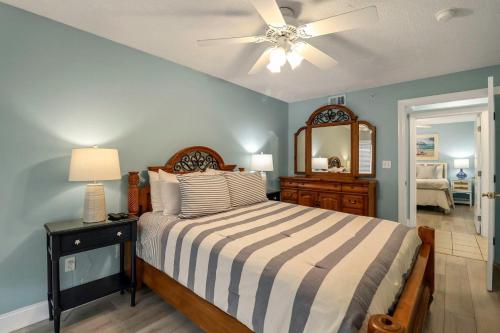 a bedroom with a bed and a ceiling fan at Sandpiper 304 in Tybee Island