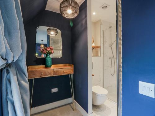 a bathroom with a sink and a toilet and a mirror at 14 Old Market Place in Bonnyrigg