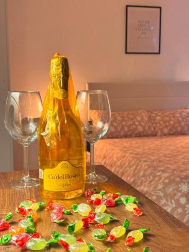 a bottle of wine on a table with two wine glasses at La Vie Est Belle in Arona