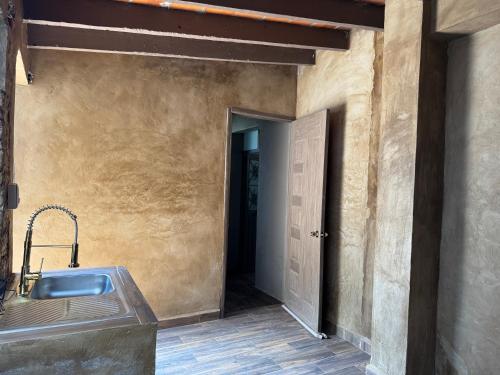 ein Bad mit einem Waschbecken neben einer Tür in der Unterkunft Galera centro de Tepoztlan in Tepoztlán