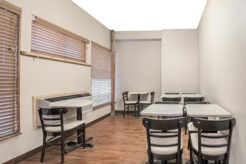 a row of tables and chairs in a room with windows at Super 8 by Wyndham Taos in Taos