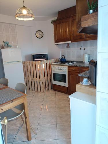 a kitchen with wooden cabinets and a stove top oven at Casa D'avó in Sabrosa