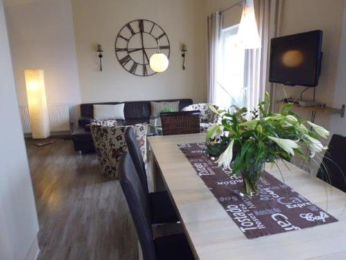 a living room with a dining table and a living room with a couch at Ferienhaus "Schöne Aussicht" in Neue Tiefe Fehmarn