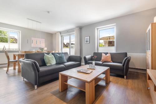 a living room with two couches and a coffee table at Inselhuus Fehmarn 1 in Petersdorf auf Fehmarn