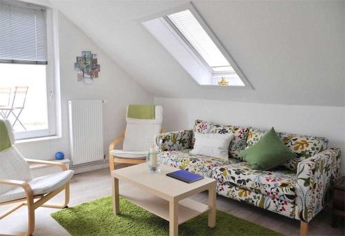 a living room with a couch and two chairs at Mala in Landkirchen