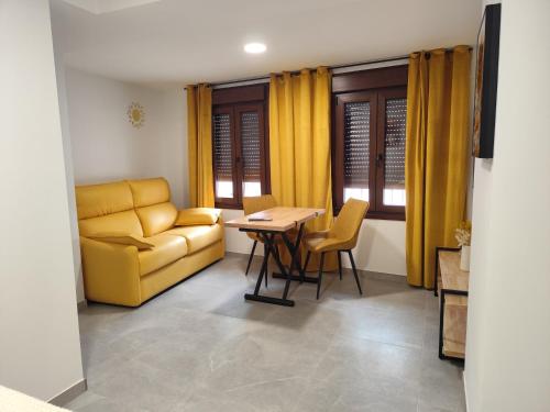 a living room with a couch and a table at Raíces de Alcalá in Alcalá del Júcar