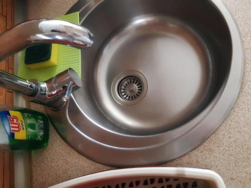 a sink with water flowing from a faucet at Cozy Studio East-Side in Cluj-Napoca