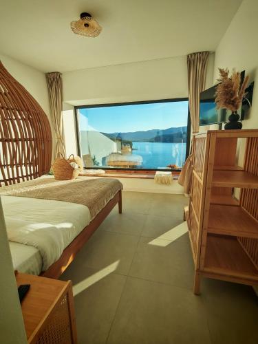a room with two beds and a large window at Moon Lake Bicaz - Aurora Sky in Buhalniţa