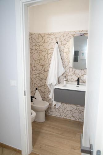 a bathroom with a sink and a toilet at B&B fly in Reggio di Calabria