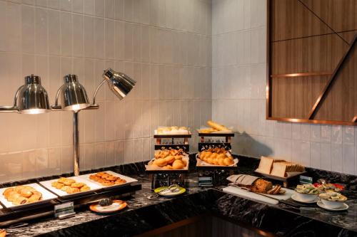 a buffet line with many different types of food at Holiday Inn Sepang - Airport in Sepang