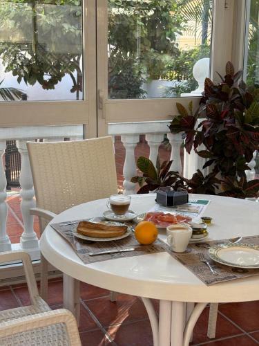 a white table with food on it on a porch at Elcano in Málaga