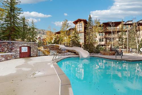 a swimming pool with a slide in a resort at Eagle Springs West 403: Blackbird Suite in Solitude