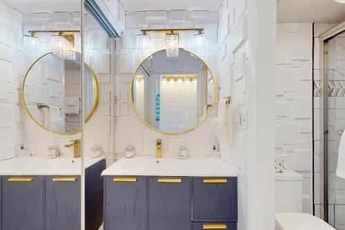 a bathroom with two sinks and a mirror at Skyline & Sand in Daytona Beach