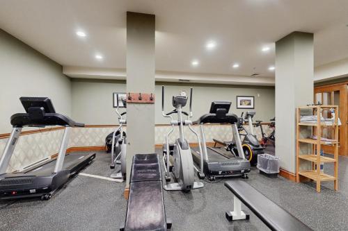a gym with several treadmills and exercise bikes at Powderhorn Lodge 102: Sego Lily Suite in Solitude
