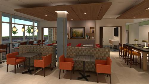 a lobby with tables and chairs in a restaurant at Holiday Inn Express & Suites - Harrisburg S - Mechanicsburg by IHG in Mechanicsburg