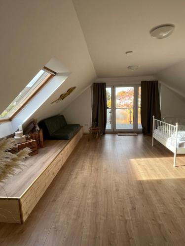a attic bedroom with a bed and a crib at Gemütliche Ferienwohnung in Neustadt am Rübenberge in Neustadt am Rübenberge