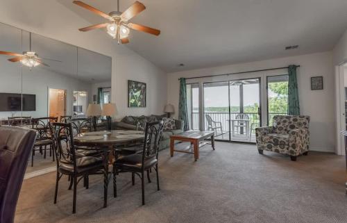 a living room with a table and chairs and a couch at Table Rock Lakeview Condo - Sanctuary 446 in Radical