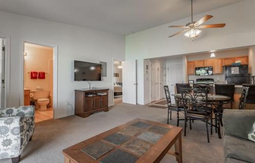 a living room with a table and a dining room at Table Rock Lakeview Condo - Sanctuary 446 in Radical