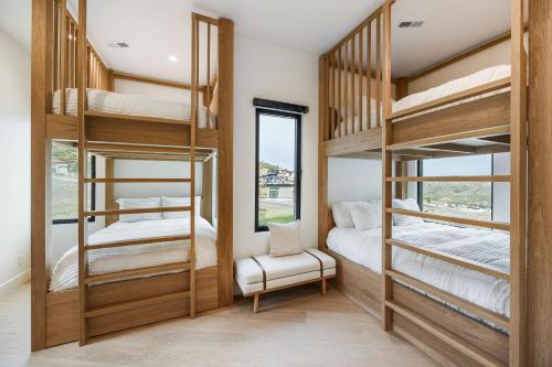 a room with bunk beds with a chair and a window at Stunning Luxury Interiors, Jordanelle Views, Private Hot Tub, Sauna, Elite Locale! in Francis