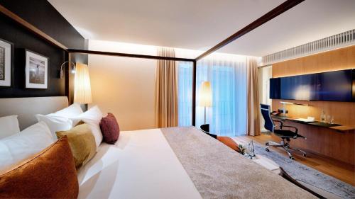 a hotel room with a large bed and a desk at B&B HOTEL RZESZÓW CENTRUM in Rzeszów