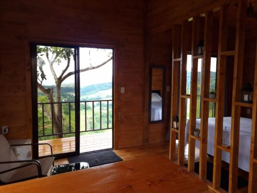 a room with a bed and a large window at Dulces Momentos PZ 