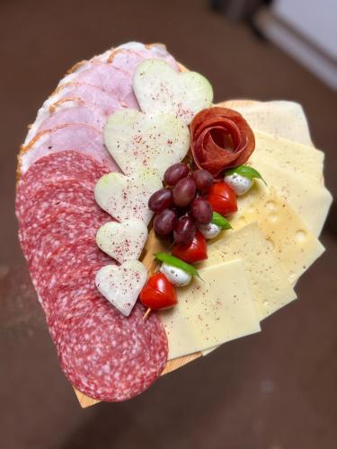 ein Teller mit Fleisch, Käse und Gemüse in der Unterkunft Sonnenplatz Apartment Ploninger NATUR in Bad Kleinkirchheim