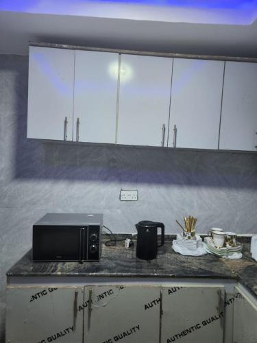 a microwave on a counter in a kitchen at Yinmic Homes in Ikorodu