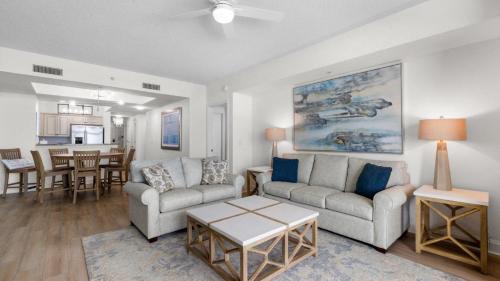 a living room with two couches and a table at North Beach Resort and Villas #1916 - Oceanfront in Myrtle Beach