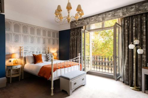 a bedroom with a bed and a window at The Westgate in Winchester