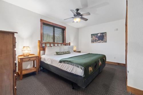 a bedroom with a bed and a ceiling fan at The Loose Moose Lodge #7 At Downtown Grand Lake N in Grand Lake
