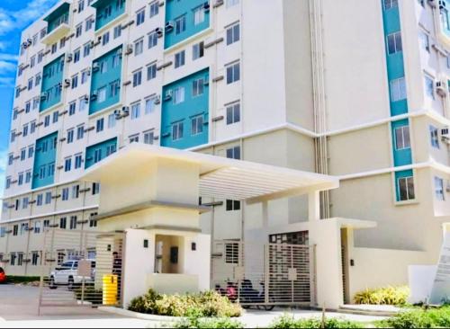 a large white building with a parking lot in front of it at Norman Condominium Unit Rental Sea View in Dumaguete
