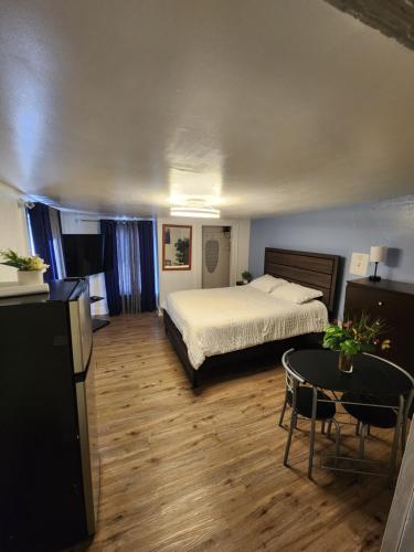 a bedroom with a bed and a table in it at Private Room - Shared Bathroom in Perth Amboy