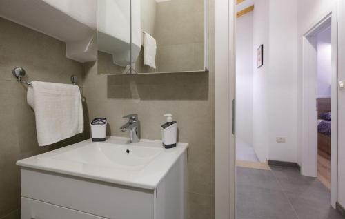 a white bathroom with a sink and a shower at House Casa Della Nonna in Kršan