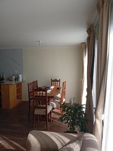 a dining room with a table and chairs in a room at Cabaña con vista al mar in Tomé