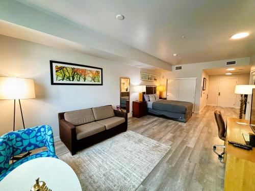 a living room with a couch and a bed at Melrose Luxe Retreat near The Grove in Los Angeles