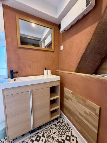 a bathroom with a sink and a mirror at Perfect pied-à-terre in Dijon in Dijon