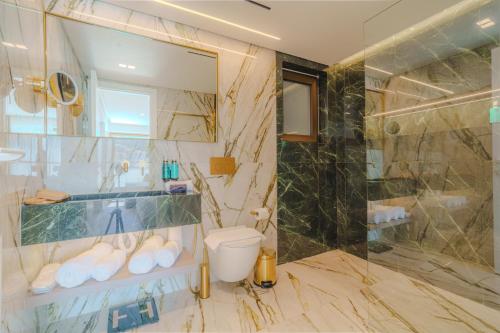 a bathroom with a toilet and a glass shower at Eternity Athens in Athens