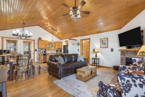 a living room with a couch and a table at Grey Moose Lodge with Amenities Access in Branson West