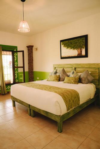 a bedroom with a large bed in a room at Hotel Pedregal in Xico