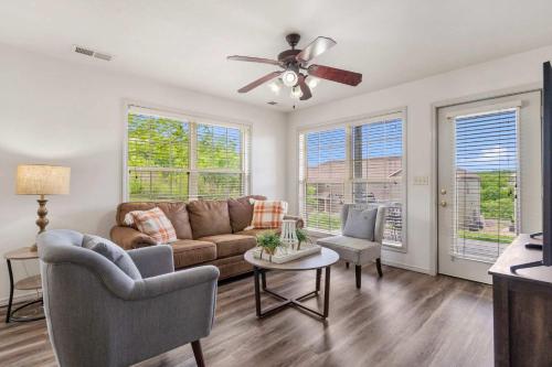 a living room with a couch and a ceiling fan at Retreat at Par Lane - Family friendly condo in Branson West