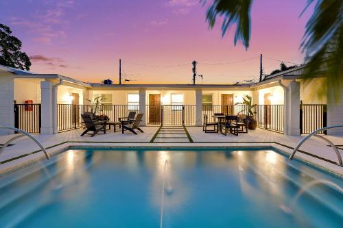 a swimming pool in front of a house at Renovated Downtown Apartment - B in West Palm Beach
