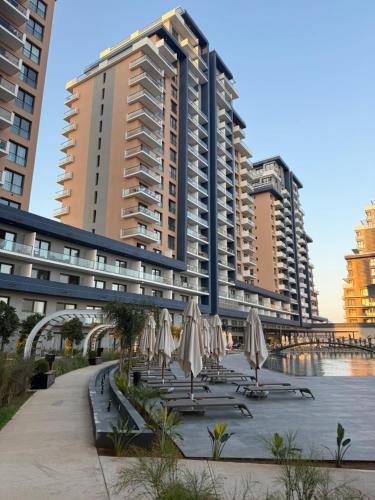 a group of chairs with umbrellas in front of a building at Riverside Life Residence in Iskele
