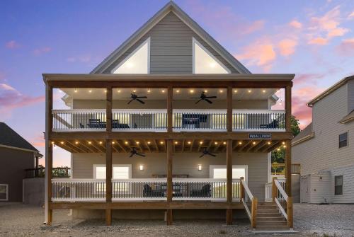 a house with a balcony with lights on it at Ingallview at Branson Cove Indoor Pool in Hollister