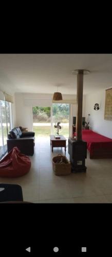 a living room with a bed and a fireplace at Petrel in La Paloma