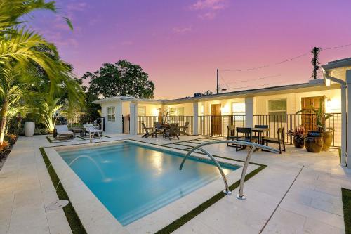 a swimming pool in front of a house at Remodeled Downtown Apartment #1 in West Palm Beach
