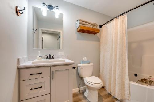 a bathroom with a sink and a toilet and a mirror at White Mtns Holiday Home! Cabin 1 Mi to Skiing in Campton Upper Village
