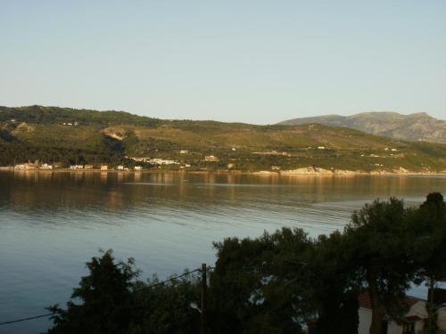 a large body of water with mountains in the background at Afroessa Studios & Apartments in Samos