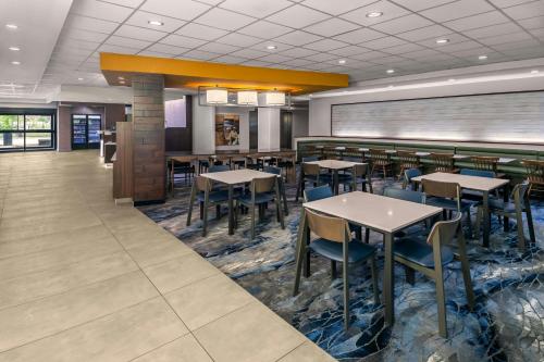 a dining area with tables and chairs in a restaurant at Fairfield Inn & Suites by Marriott Edmonton North in Edmonton