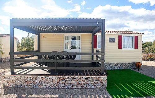 a screened in porch of a tiny house at Pet Friendly Stacaravan In Drnis With Wifi in Brištane